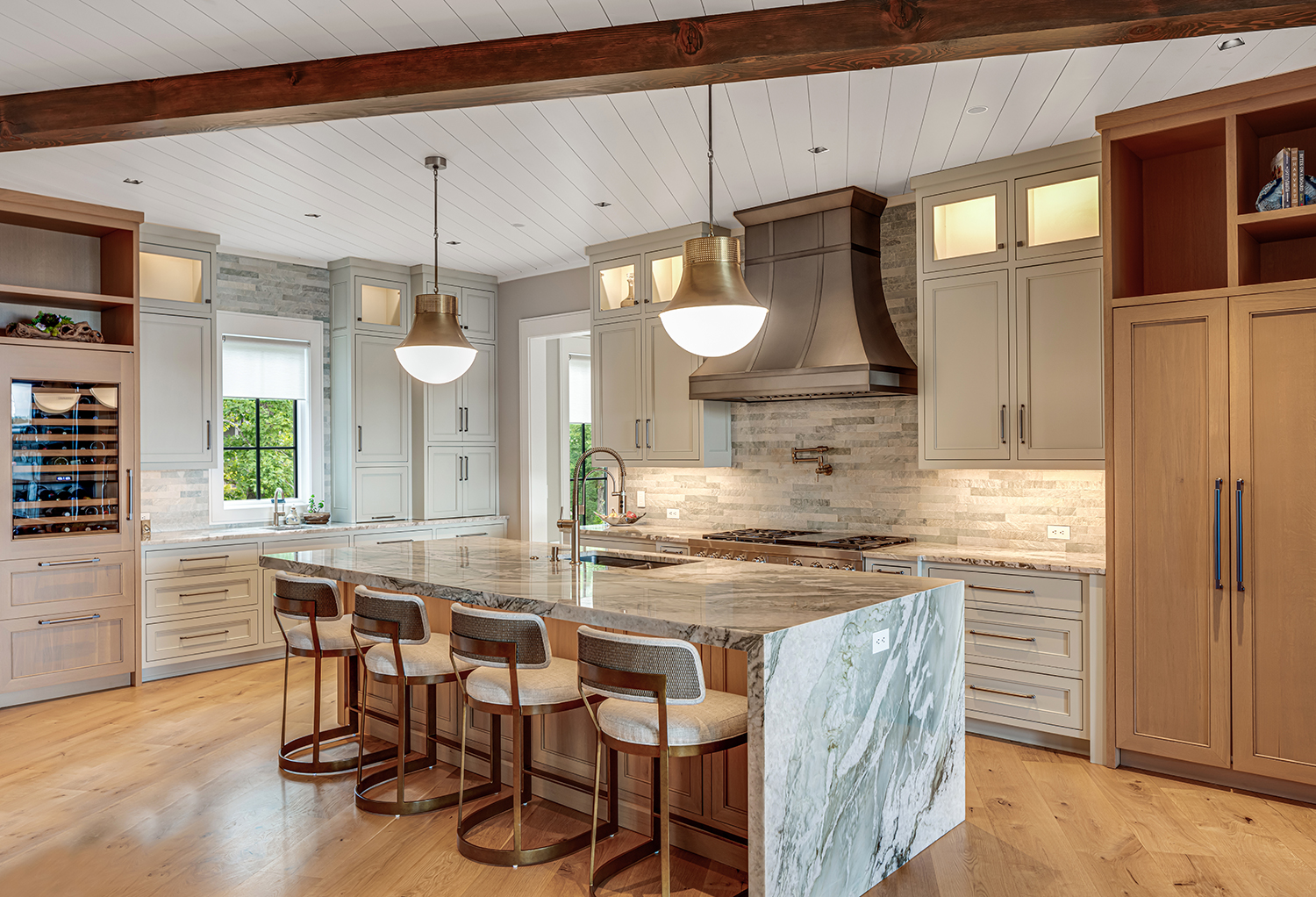 Custom kitchen with marble waterfall island, sage cabinetry, exposed wood beams, and brass pendant lighting — Mac & Morgan Interiors, Lake Keowee